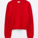 Red cashmere-blend jumper laid flat, featuring a round neckline, long sleeves, ribbed cuffs and hem, and gently dropped shoulders.