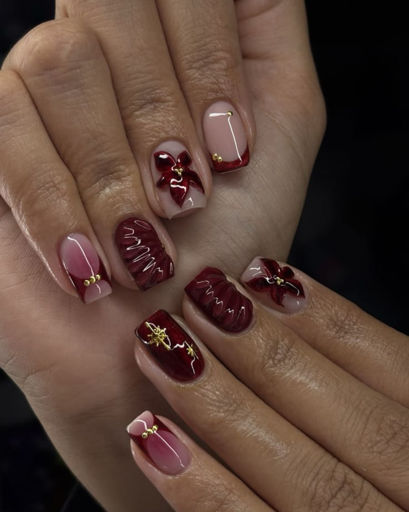 Short burgundy nails with 3D flowers, ribbed shell texture and gold star studs. Short nail design