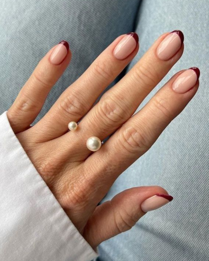 Nude short nails with burgundy French tips